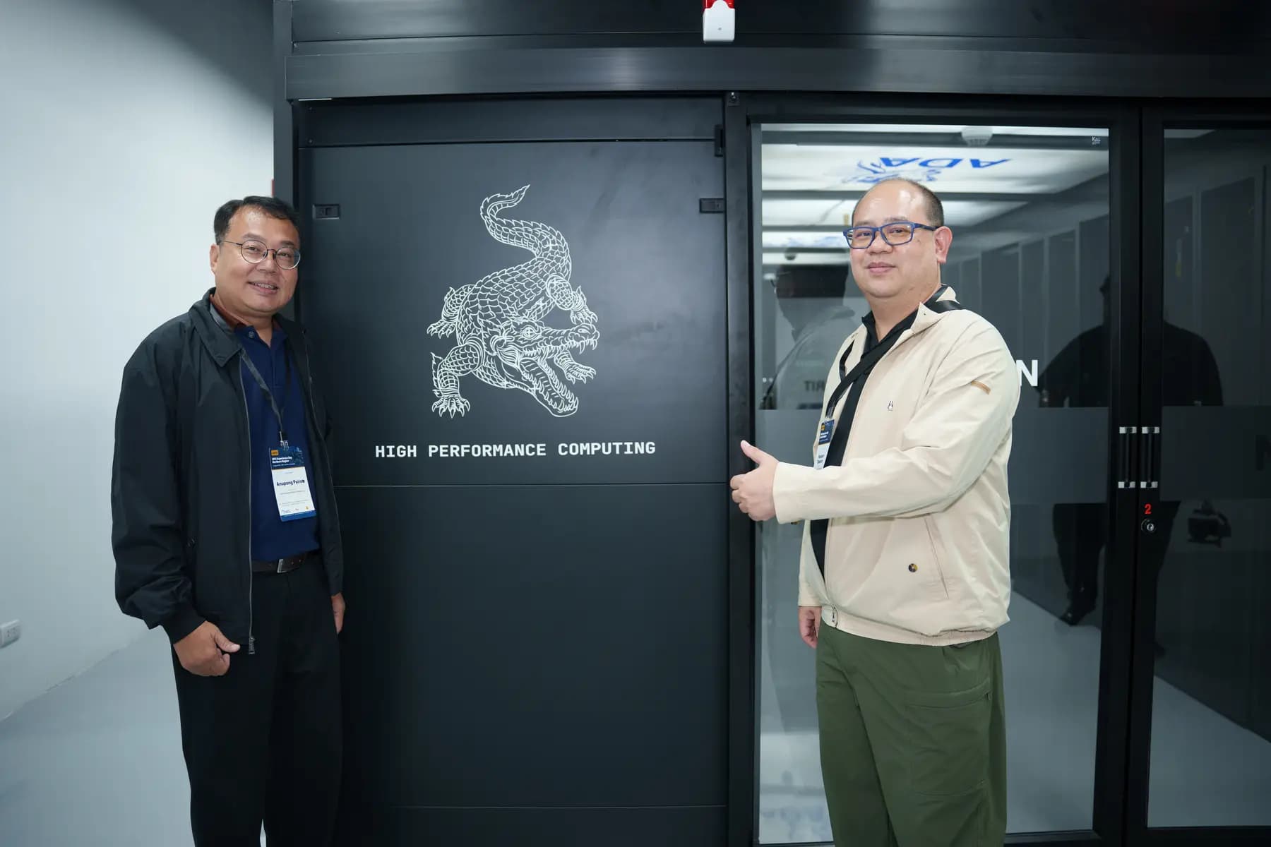 ผู้แทนยืนถ่ายภาพหน้าประตูระบบ high performance computing